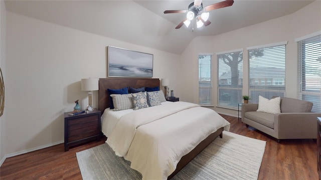 bedroom featuring lofted ceiling, a ceiling fan, wood finished floors, and baseboards