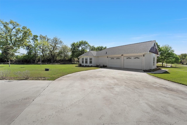 view of front of property with a garage, driveway, and a front yard