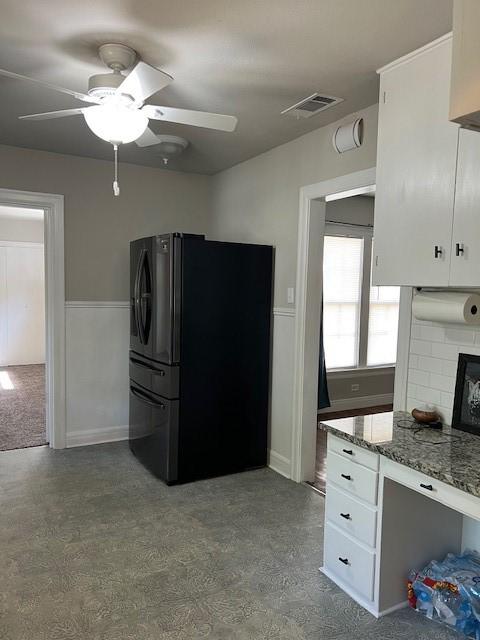 kitchen featuring freestanding refrigerator, visible vents, white cabinetry, and ceiling fan
