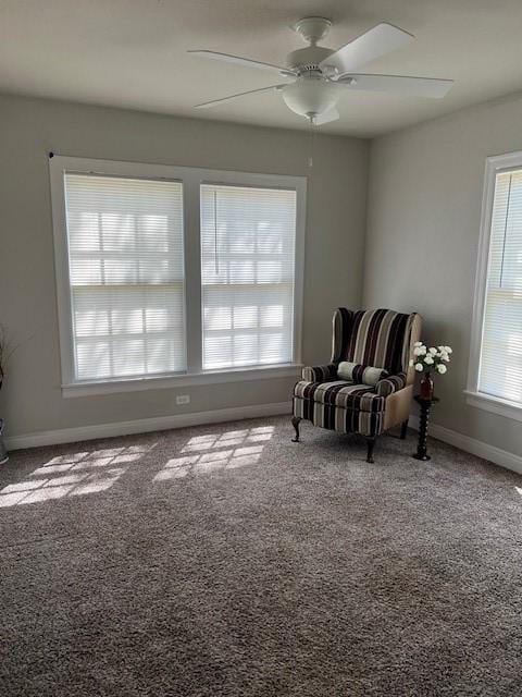 sitting room featuring a ceiling fan, baseboards, and carpet floors