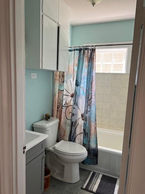 full bath with shower / bath combo with shower curtain, vanity, and toilet