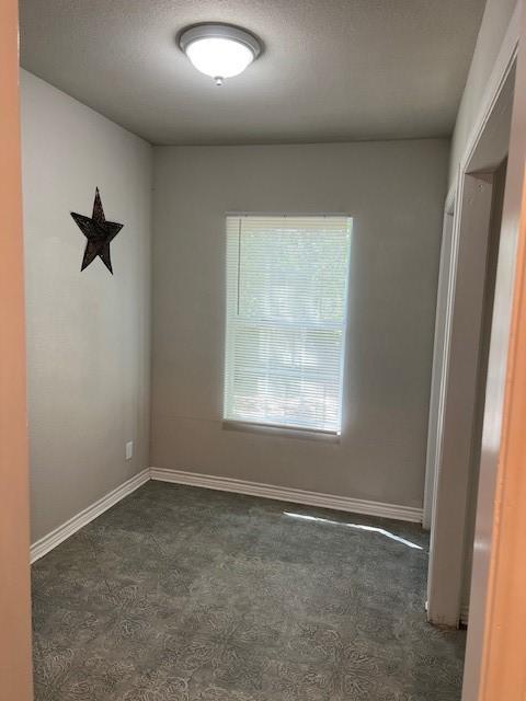 spare room featuring baseboards