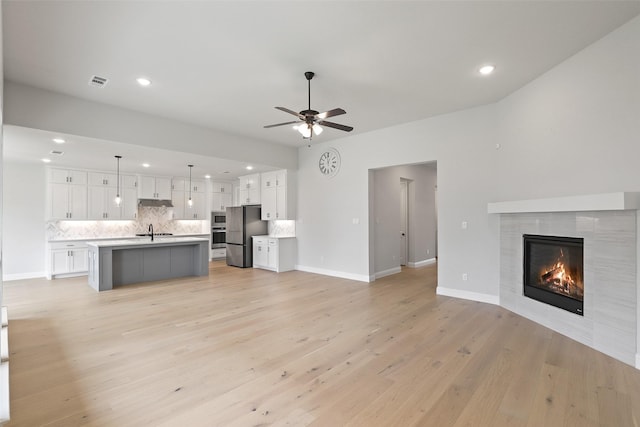 1525 Wild Indigo Dr, Mansfield, TX 76063 - unfurnished living room featuring recessed lighting, visible vents, a ceiling fan, and a fireplace