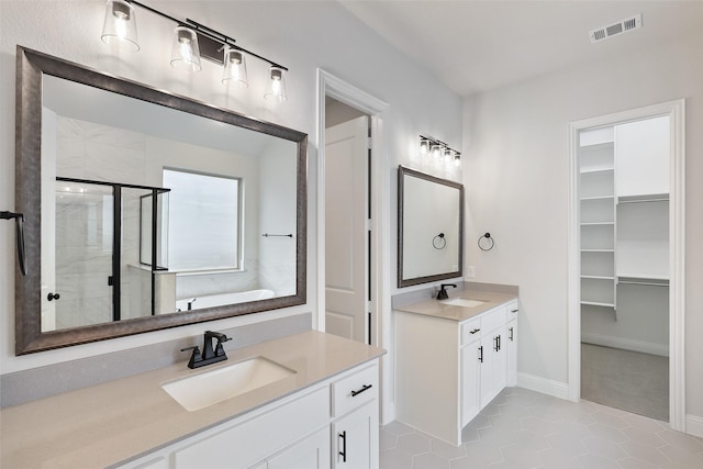 1525 Wild Indigo Dr, Mansfield, TX 76063 - full bath featuring tile patterned floors, two vanities, a sink, visible vents, and a shower stall