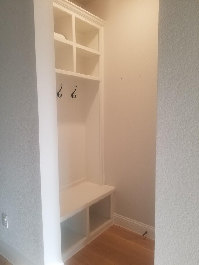 1525 Wild Indigo Dr, Mansfield, TX 76063 - mudroom featuring wood finished floors, baseboards, and a textured wall