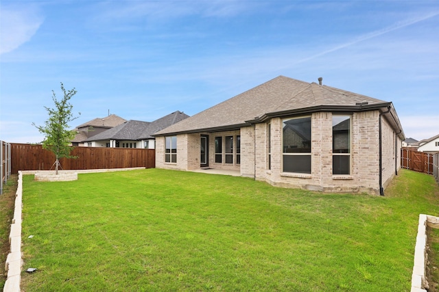 1525 Wild Indigo Dr, Mansfield, TX 76063 - back of house featuring brick siding, a lawn, a shingled roof, and a fenced backyard