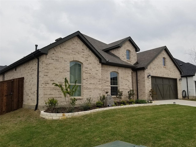 1525 Wild Indigo Dr, Mansfield, TX 76063 - french country inspired facade with driveway, fence, a front yard, a garage, and brick siding