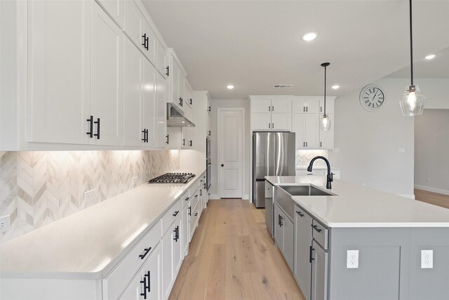1525 Wild Indigo Dr, Mansfield, TX 76063 - kitchen featuring recessed lighting, under cabinet range hood, stainless steel appliances, and light wood-style floors