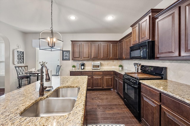 14116 Rabbit Brush Ln, Fort Worth, TX 76052 - kitchen featuring dark wood-style floors, a sink, arched walkways, black appliances, and a notable chandelier