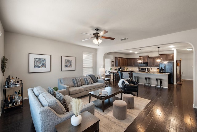 14116 Rabbit Brush Ln, Fort Worth, TX 76052 - living area with arched walkways, visible vents, a ceiling fan, and dark wood-style floors