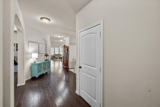 14116 Rabbit Brush Ln, Fort Worth, TX 76052 - corridor featuring baseboards, arched walkways, and dark wood-type flooring