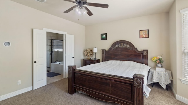 bedroom featuring light carpet, visible vents, baseboards, a ceiling fan, and ensuite bath