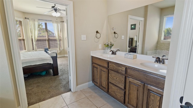 ensuite bathroom featuring ceiling fan, a healthy amount of sunlight, a sink, and connected bathroom