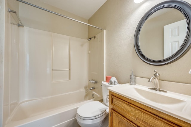 bathroom featuring shower / bath combination, a textured wall, toilet, and vanity