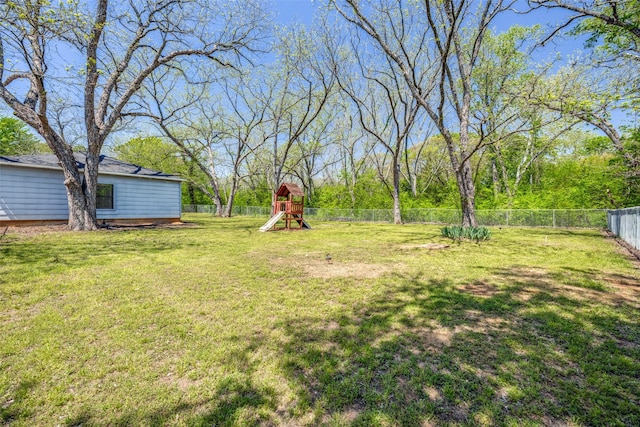 view of yard with a fenced backyard and a playground