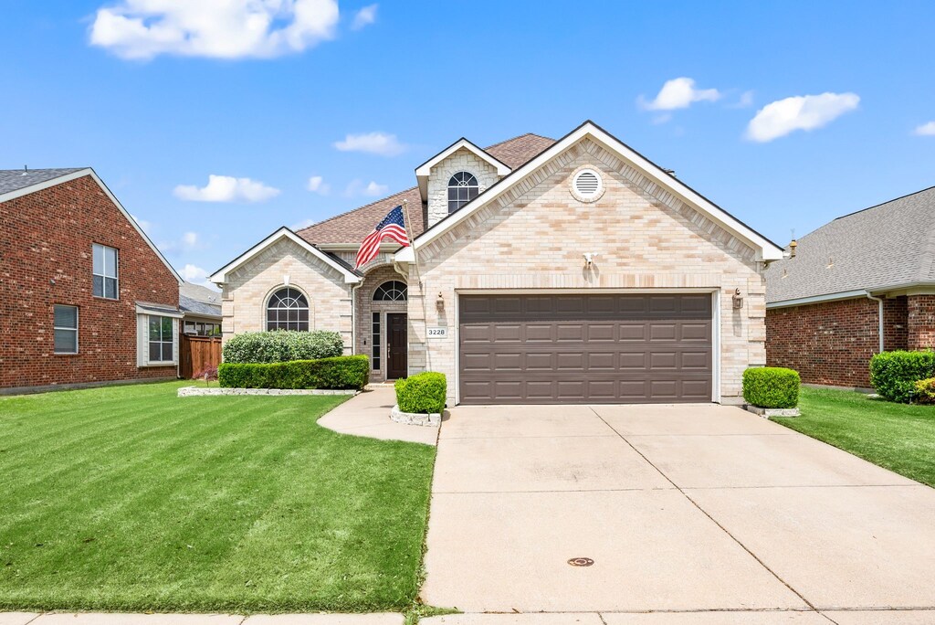 3228 Porma, Grand Prairie, TX 75054 - french country style house featuring brick siding, an attached garage, driveway, and a front yard