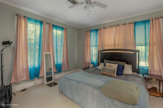 bedroom featuring a ceiling fan, crown molding, and visible vents