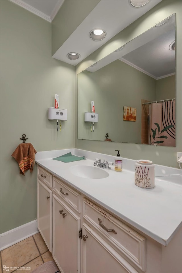 bathroom featuring baseboards, tile patterned flooring, vanity, and ornamental molding