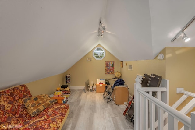 bonus room with vaulted ceiling, wood finished floors, visible vents, and baseboards