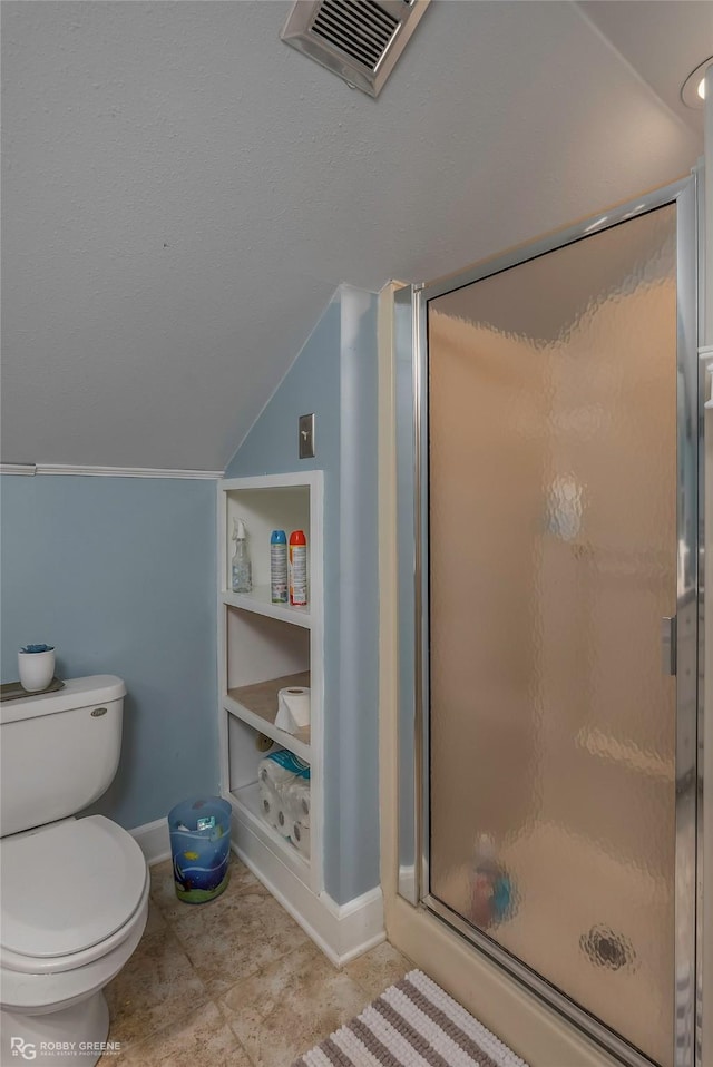 bathroom with toilet, a stall shower, visible vents, baseboards, and lofted ceiling