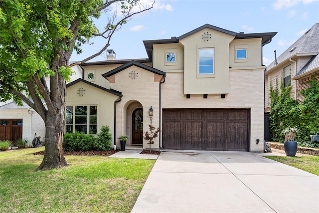mediterranean / spanish-style home featuring concrete driveway, an attached garage, brick siding, and a front yard