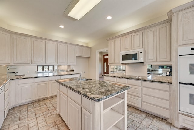 1281 Vz County Road 2120, Canton, TX 75103 - kitchen with dark stone counters, a sink, white appliances, and recessed lighting