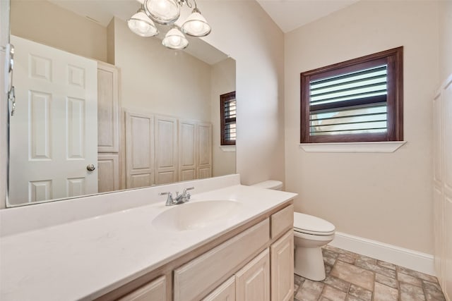 1281 Vz County Road 2120, Canton, TX 75103 - bathroom with vanity, baseboards, toilet, a notable chandelier, and stone finish floor