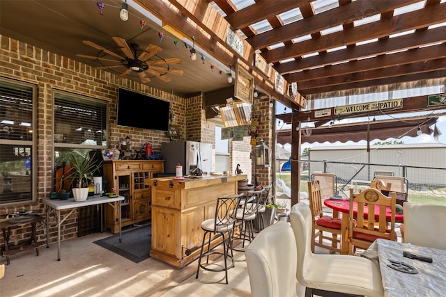 view of patio / terrace featuring a pergola, outdoor dry bar, fence, and ceiling fan
