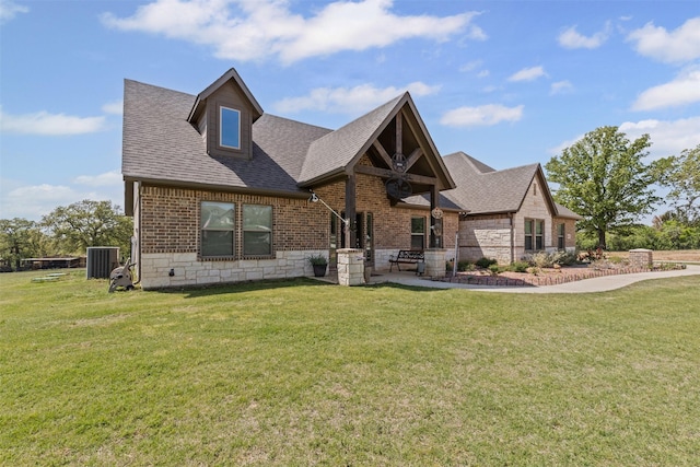 craftsman-style home with a front lawn, brick siding, and a shingled roof