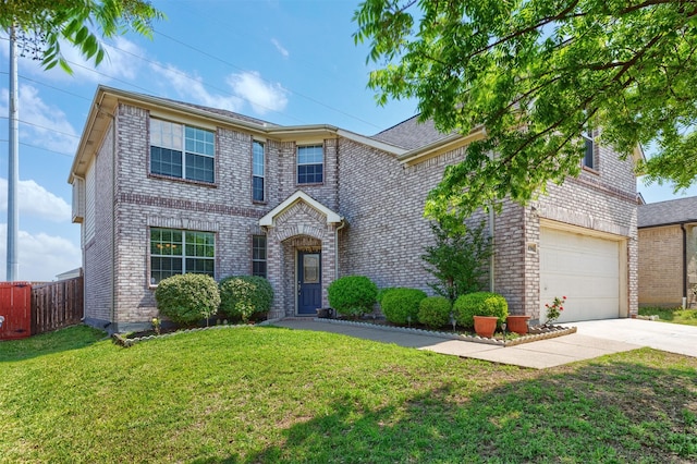 traditional-style house with brick siding, a front yard, concrete driveway, and fence