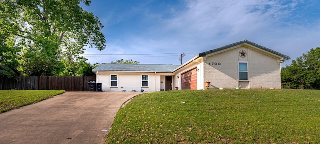 ranch-style home with a front lawn, concrete driveway, and fence
