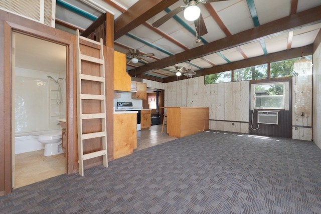 kitchen with wood walls, carpet floors, cooling unit, electric range, and ceiling fan