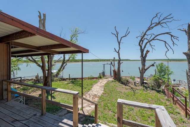 exterior space featuring a deck with water view