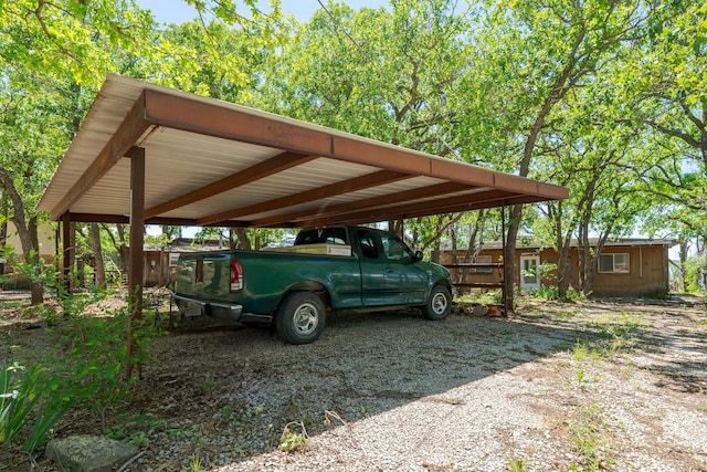 view of vehicle parking with a detached carport and driveway