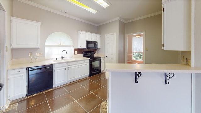 6926 Wickliff Trl, Plano, TX 75023 - kitchen featuring black appliances, a sink, crown molding, white cabinets, and a peninsula