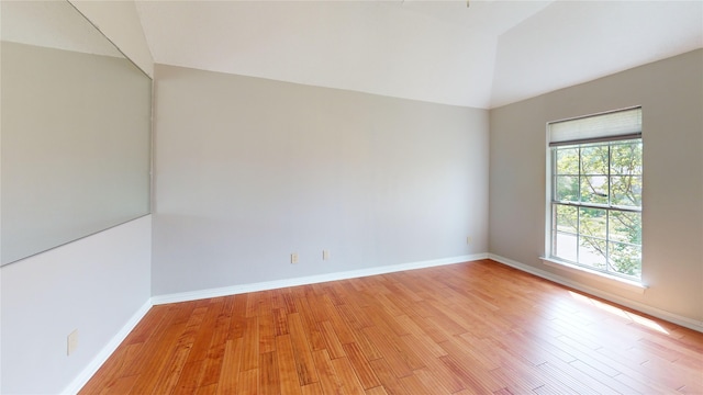 6926 Wickliff Trl, Plano, TX 75023 - empty room with light wood finished floors, baseboards, and lofted ceiling