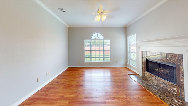 6926 Wickliff Trl, Plano, TX 75023 - unfurnished living room with a ceiling fan, light wood-style floors, a tile fireplace, crown molding, and baseboards