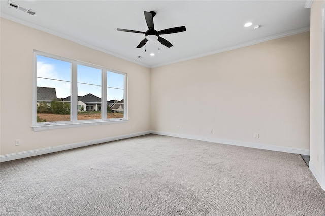 spare room featuring baseboards, crown molding, visible vents, and carpet