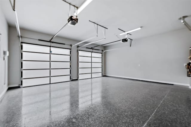 garage with baseboards and a garage door opener