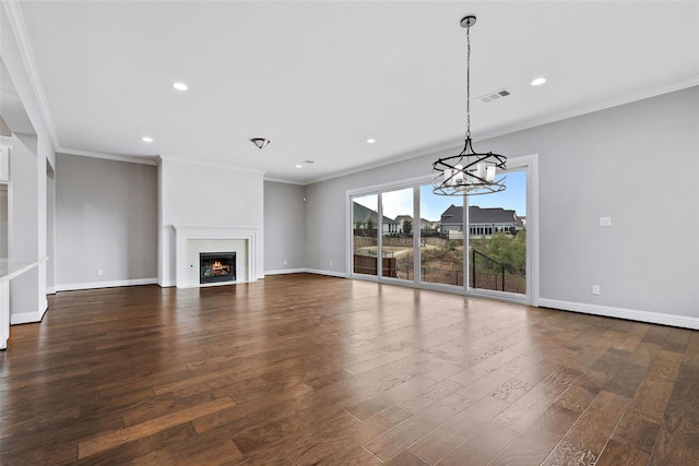 unfurnished living room featuring baseboards, dark wood-style flooring, a chandelier, and visible vents