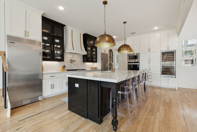 1501 Latigo Ct, Prosper, TX 75078 - kitchen featuring built in appliances, wine cooler, light countertops, light wood finished floors, and recessed lighting