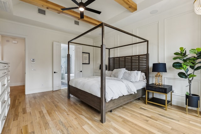 1501 Latigo Ct, Prosper, TX 75078 - bedroom featuring beamed ceiling, light wood-type flooring, a decorative wall, and crown molding