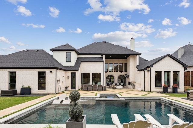 1501 Latigo Ct, Prosper, TX 75078 - rear view of house featuring an outdoor living space, a patio area, brick siding, a pool with connected hot tub, and roof with shingles