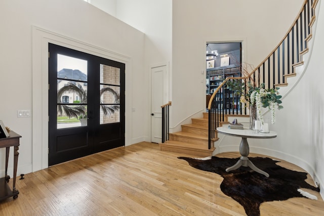 1501 Latigo Ct, Prosper, TX 75078 - foyer entrance with stairs, a towering ceiling, wood finished floors, french doors, and baseboards