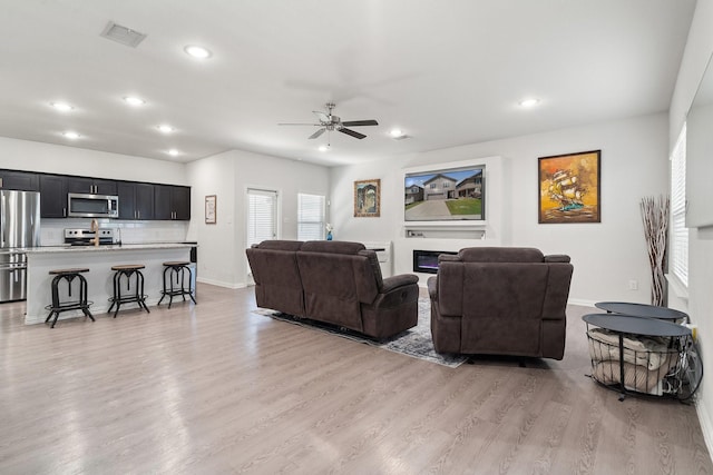 4652 Raleigh Dalton Rd, Dallas, TX 75227 - living room with recessed lighting, visible vents, light wood-style floors, baseboards, and ceiling fan