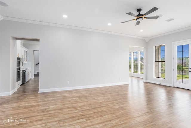 unfurnished living room with plenty of natural light, ceiling fan, crown molding, and light wood-style flooring