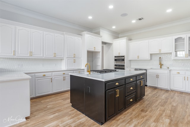 kitchen featuring tasteful backsplash, appliances with stainless steel finishes, and white cabinetry