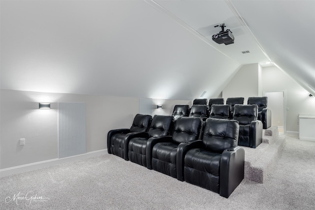 home theater featuring vaulted ceiling, carpet flooring, visible vents, and baseboards
