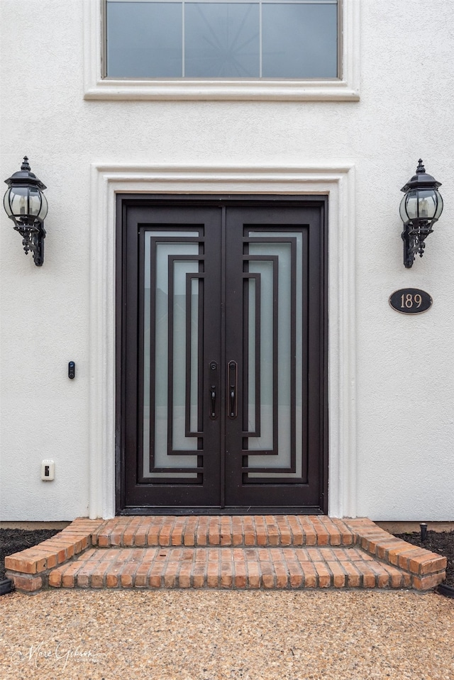 entrance to property with stucco siding