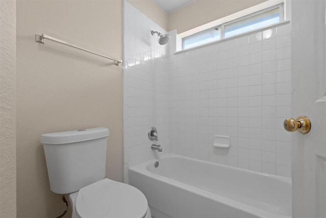 bathroom with bathtub / shower combination and toilet